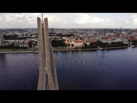 around drone shot Vanšu Bridge, the Daugava River in Riga, Latvia. Cars, the landscape of Riga.