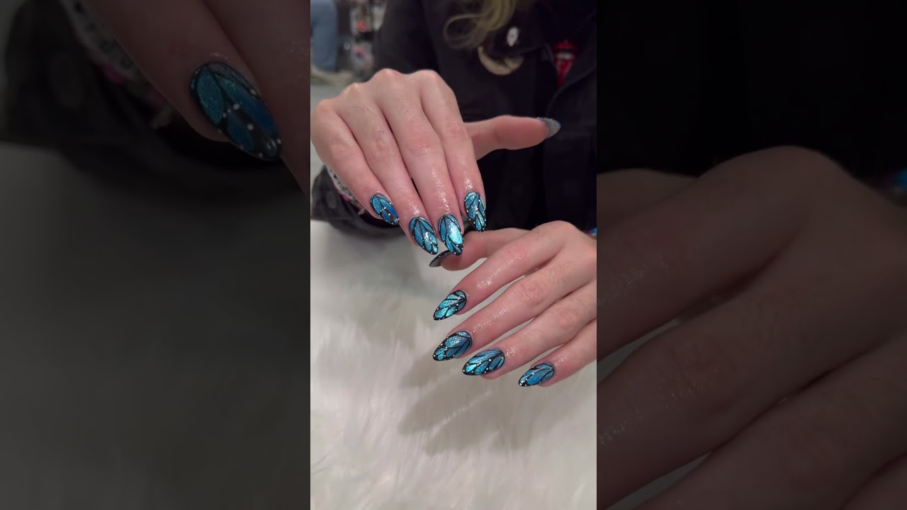 This nail design features a butterfly shape