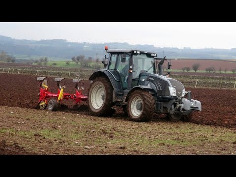 Ploughing with Valtra, while John Deere Ploughs Next Field.