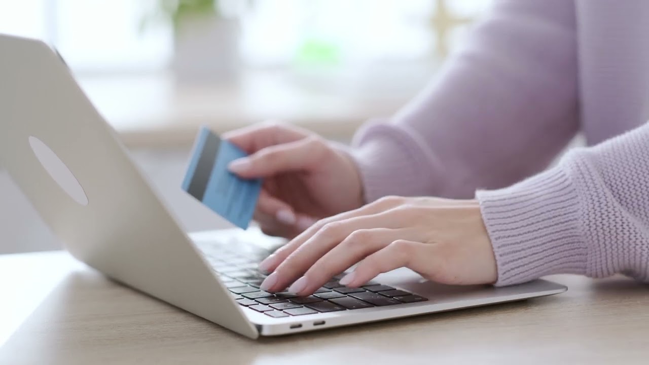 Woman Holding Credit Card and using laptop, Online Shopping