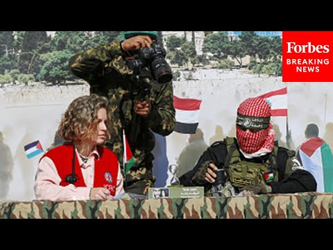 Red Cross Official Sign Papers With Member Of Hamas To Take Custody Of Three Israeli Hostages