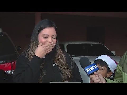 Family surprised with check in Operation Blue Santa
