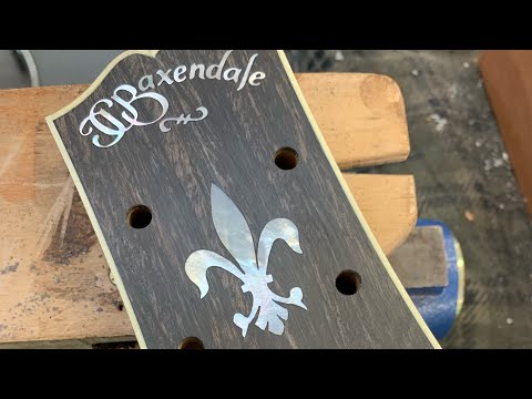 How to cut a mother of pearl fluer de lis inlay for a guitar.