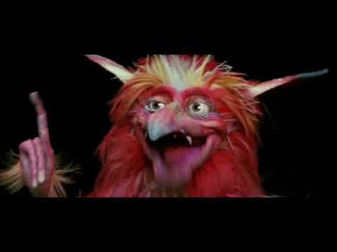 Trailer still: Sarah on a stair landing looking up at Jareth across impossible geometry as the song 'Within You' looms