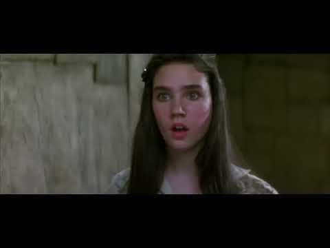 Trailer frame: the crystal-ball masquerade with masks and chandeliers—strings and synth pads implied