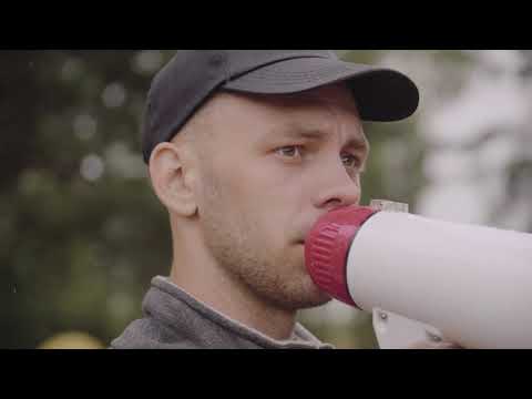 Close-Up View of Man Talking through a Megaphone