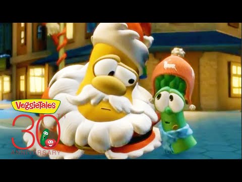 Two VeggieTales characters in a snowy town: a large yellow bearded figure beside a green cucumber in a pink hat, with a 30th anniversary logo nearby.