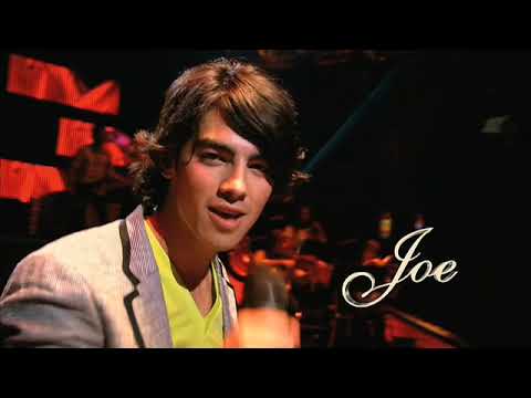 UK trailer thumbnail with 3D title card and Jonas Brothers performing under red lights