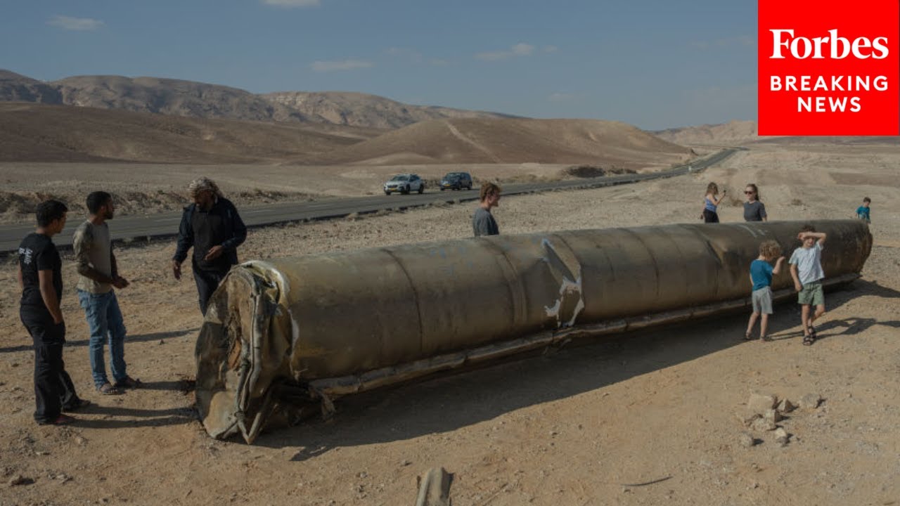 People Take Pictures Next To Remnants Of Iranian Missile That Landed In Southern Israel