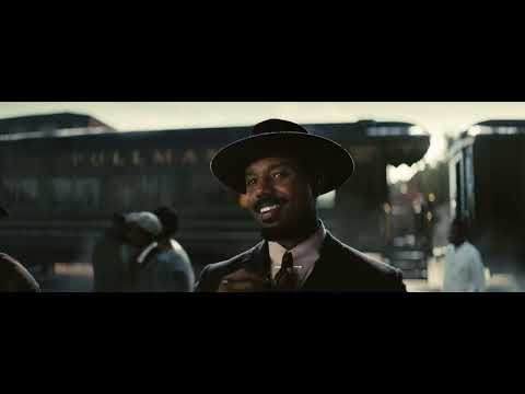 Trailer 2 thumbnail: crowd pressed around the bandstand as a bow strikes strings