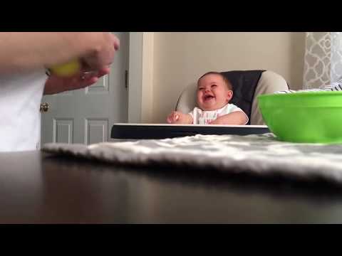 Baby belly laughs at dad who keeps dropping her snack.