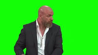 Triple H is surprised and looks behind him green screen