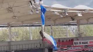 Parachutist dangles from stadium roof during botched stunt in France delaying rugby match