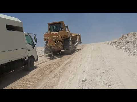 our service truck pulling bay Caterpillar D9 dozer. stack in desert