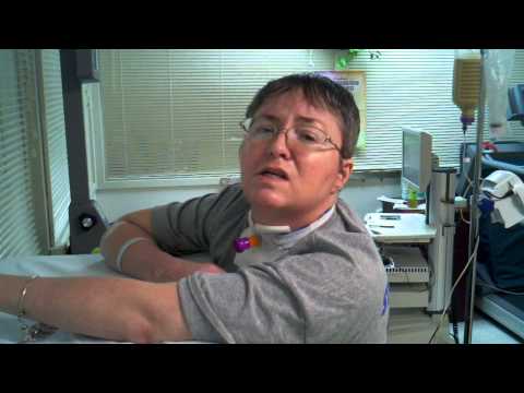 Lori standing on her own in a standing frame 15 months after her stroke.