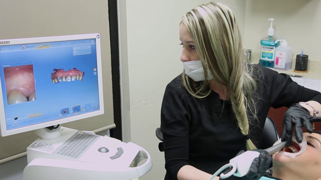 Massapequa Park dental assistant taking digital images of a patient's teeth