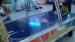 playing air hockey at Tunjungan Plaza Surabaya, Indonesia