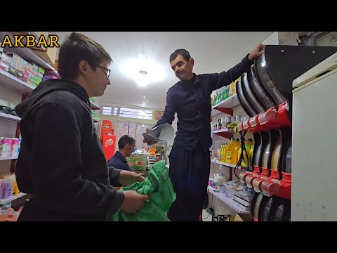 Filling the shelves in Akbar's shop in the midst of hardship