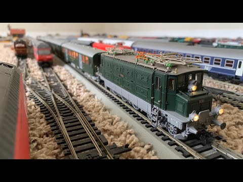 An authentic model of SBB CFF FSS Ae 3/5 I locomotive with lightweight steel carriages train