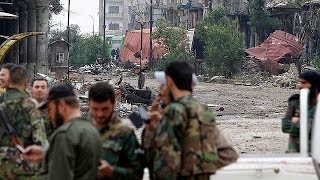 Syrian forces retake control of Homs as rebels exit