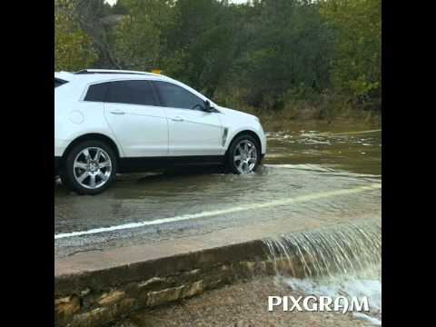 Car drives through low water crossing