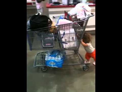 muscle head baby girl pushing shopping cart