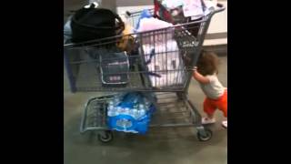 muscle head baby girl pushing shopping cart