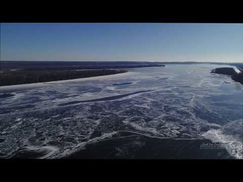 Aerial drone flight over the Mississippi River when it's frozen