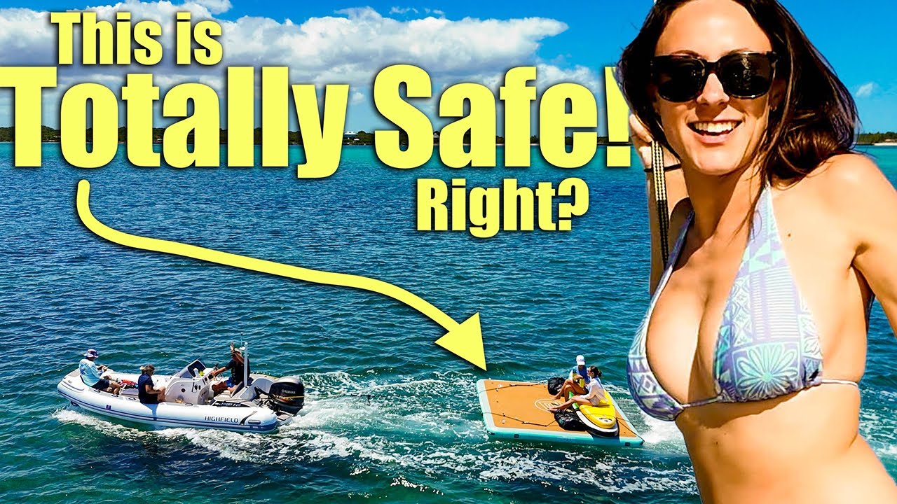 Towing a floating dock with the bikini clad ladies on the back