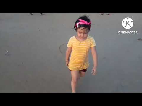 Shatakshi playing with sand and ball at Sea Beach.