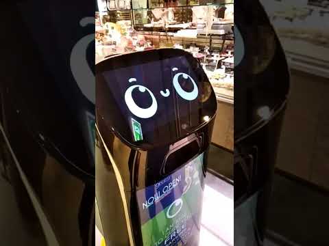 , title : 'Futuristic robots in Greens supermarket.'