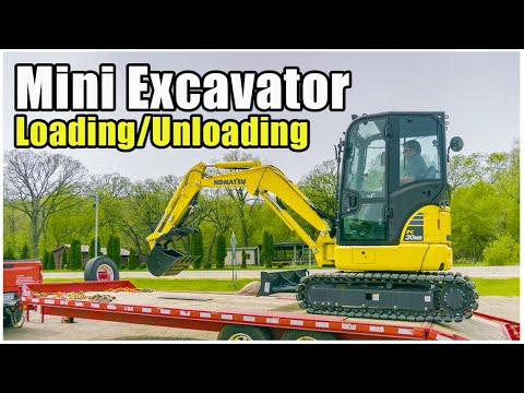 Part of a video titled How to Load/Unload a Mini Excavator | Heavy Equipment Operator Training