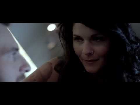 Trailer still: tour-bus window reflections at night as a minor-key cue rises