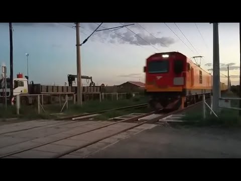 Train with shipping containers speeding past me. South african railways. Sar