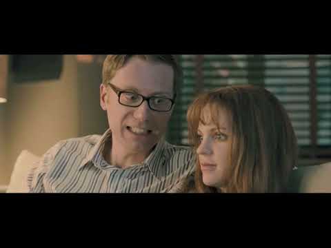 I Give It a Year trailer frame suggesting boardroom scenes aligned with crisp electronic-pop cues