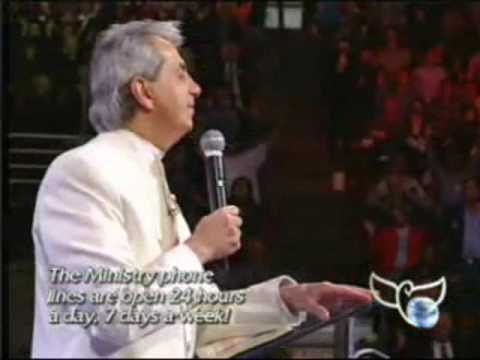 Benny Hinn sings "There's Something About That Name"
