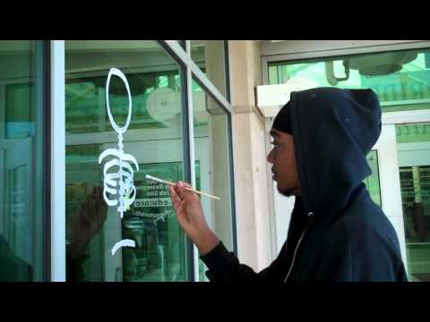 Student paints campus windows for Homecoming