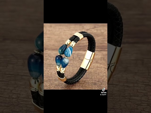 Vídeo relacionado con Pulsera de piel color negro del Atlético de Madrid. Varias tiras trenzadas y lisas en cuero 100% vacuno. Cierre de seguridad con imán. Se entrega en caja negra con el Escudo en color plata.