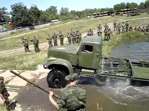 KrAZ 255 Resetting the pontoon bridge. Military equipment.