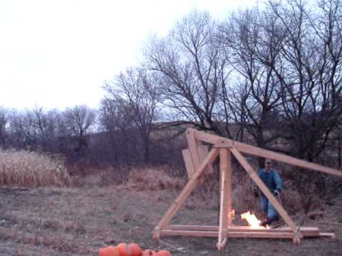 trebuchet catapult throwing pumpkin on fire