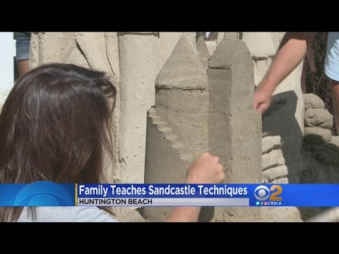 Family Teaches Techniques For Making Sandcastles
