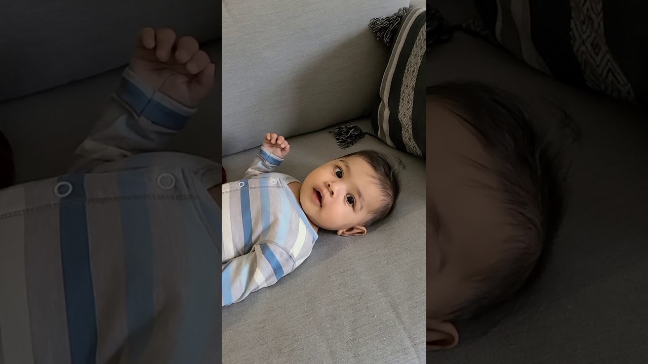 Laughing baby with mommy kissing  him. Funny baby and mommy moment.