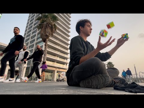 3 Rubik’s cubes solved while juggling