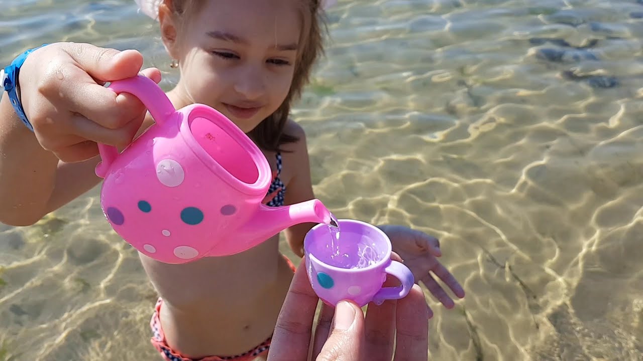 Kids playing on the beach . They making ice cream and cakes from sand. Video 2016