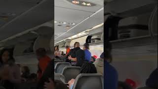 Frontier Airlines passenger gets into fight on plane; tries to bite cops after getting carried off