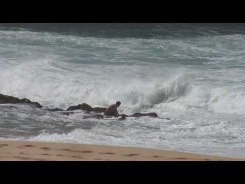 Surfer Getting Washed On Rocks