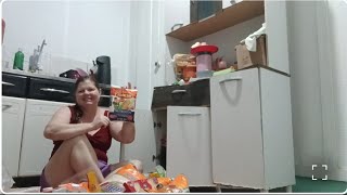 Organizing the month's groceries in the cupboard