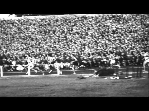 Herb Elliot sets a new record at an all star mile race in Dublin, Ireland. HD Stock Footage