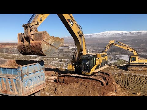 Caterpillar 365C Excavator Loading Mercedes And MAN Trucks