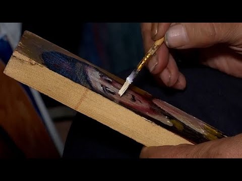 Ukrainian artist paints icons on ammunition boxes to boost soldiers' morale